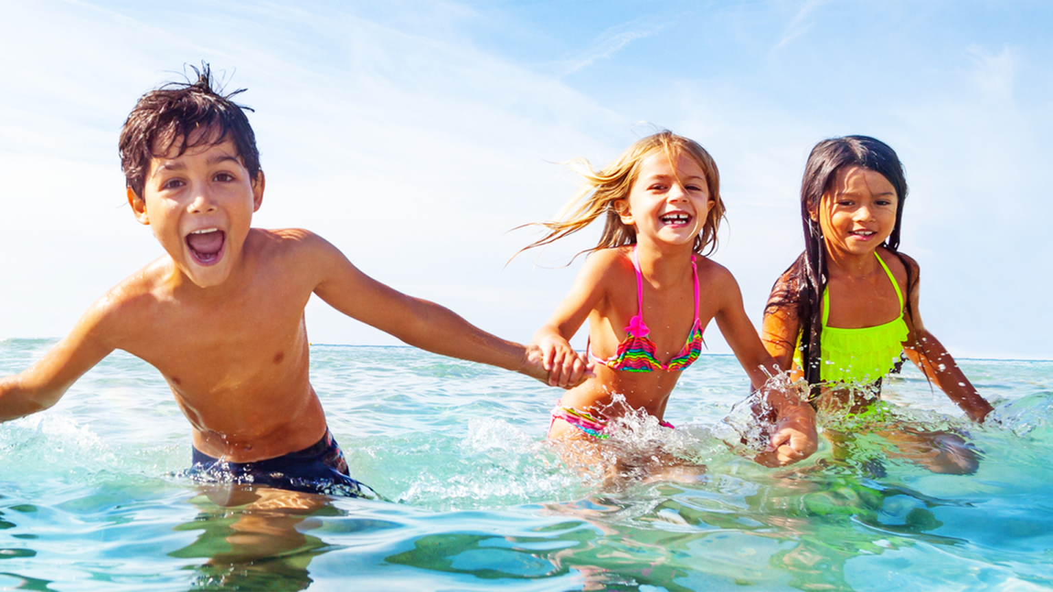 kids in the water at the beach