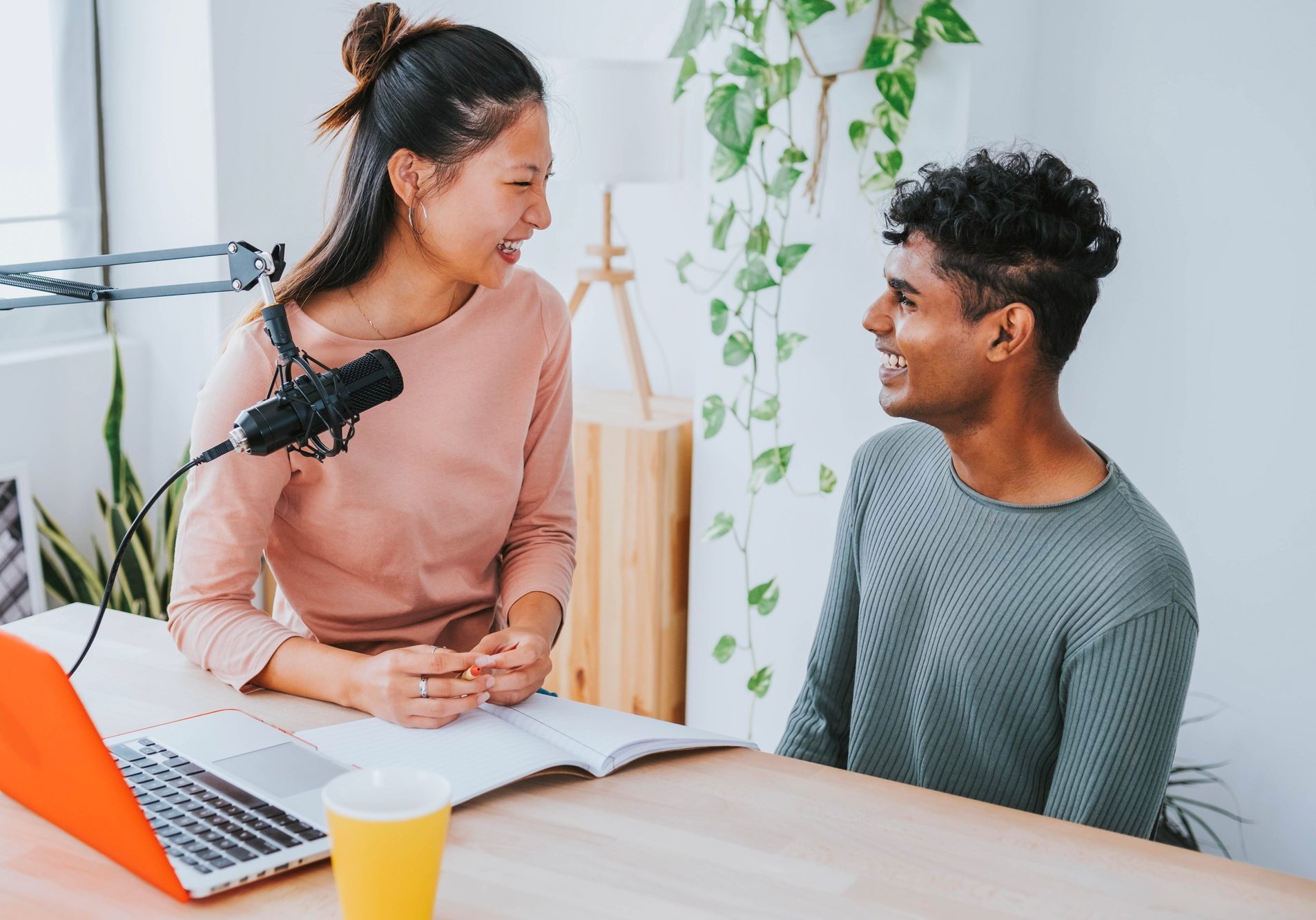 Female radio presenter interviewing guest in podcast radio station - Broadcast live radio concept