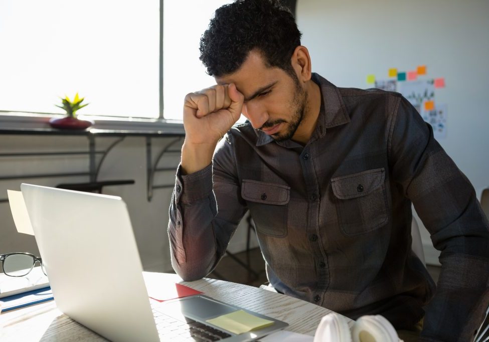 Frustrated businessman sitting at desk